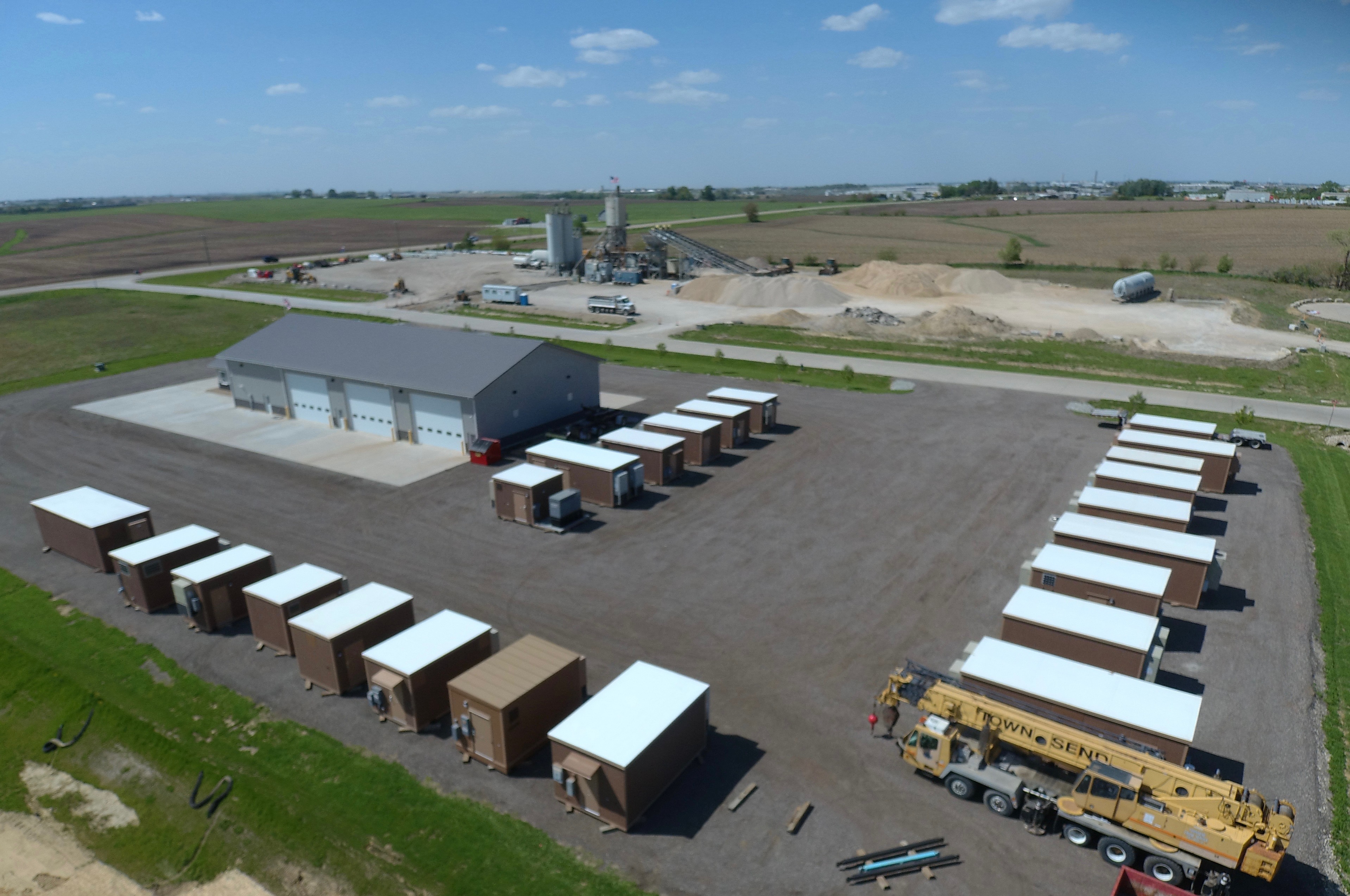 Midwest Surplus yard with surplus telecom shelters and equipment
